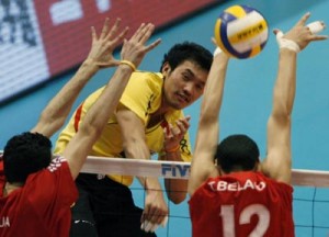 Thailand's Tabwises spikes the ball past Algeria's Ali and Toufik during their 2008 World Men's Olympic Volleyball Qualification Tournament in Tokyo