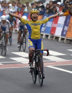 Thailand's Jutatip Maneephan celebrates winning the women's road racing competition during the 17th Asian Games in Incheon